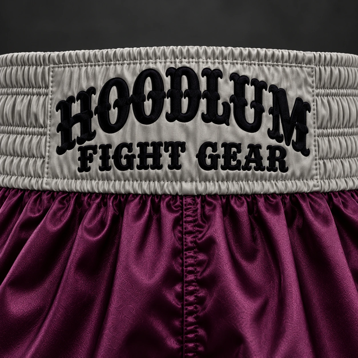 Beyond Ring Boxing Shorts — Plum / Pewter — Branding detail (AI demo concept)