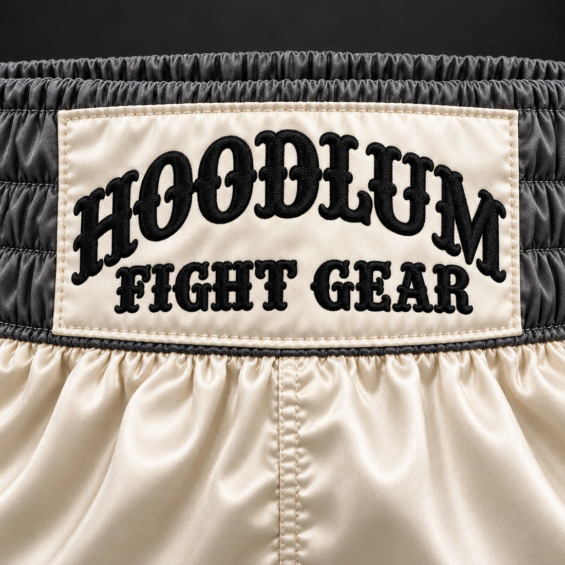 Heritage Satin Boxing Shorts — Bone / Graphite — Branding detail (AI demo concept)