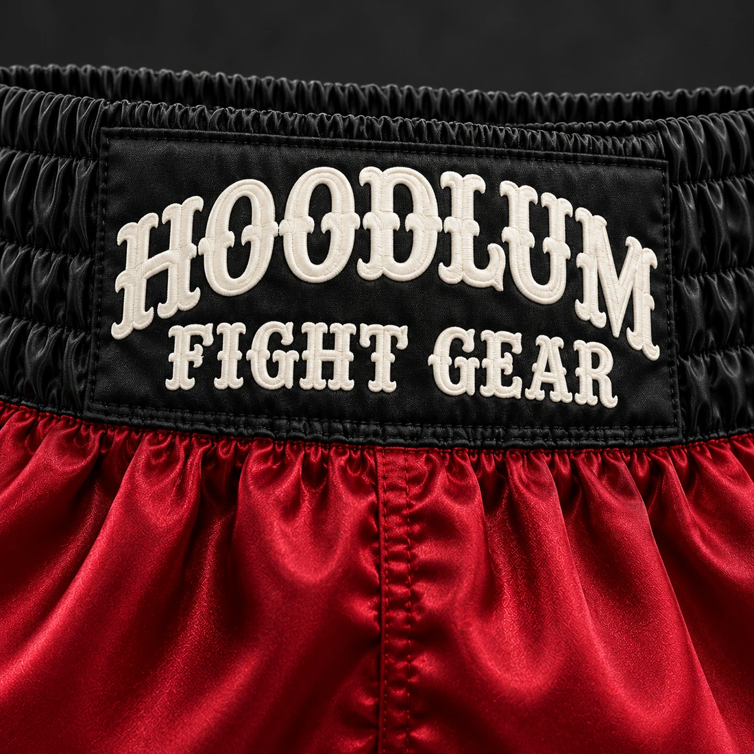 Heritage Satin Boxing Shorts — Crimson / Onyx — Branding detail (AI demo concept)