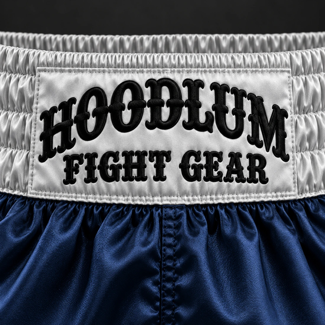 Heritage Satin Boxing Shorts — Midnight / Ice — Branding detail (AI demo concept)