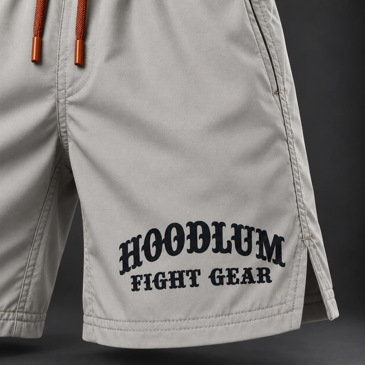 Onyx Fight Shorts — Stone / Rust — Branding detail (AI demo concept)