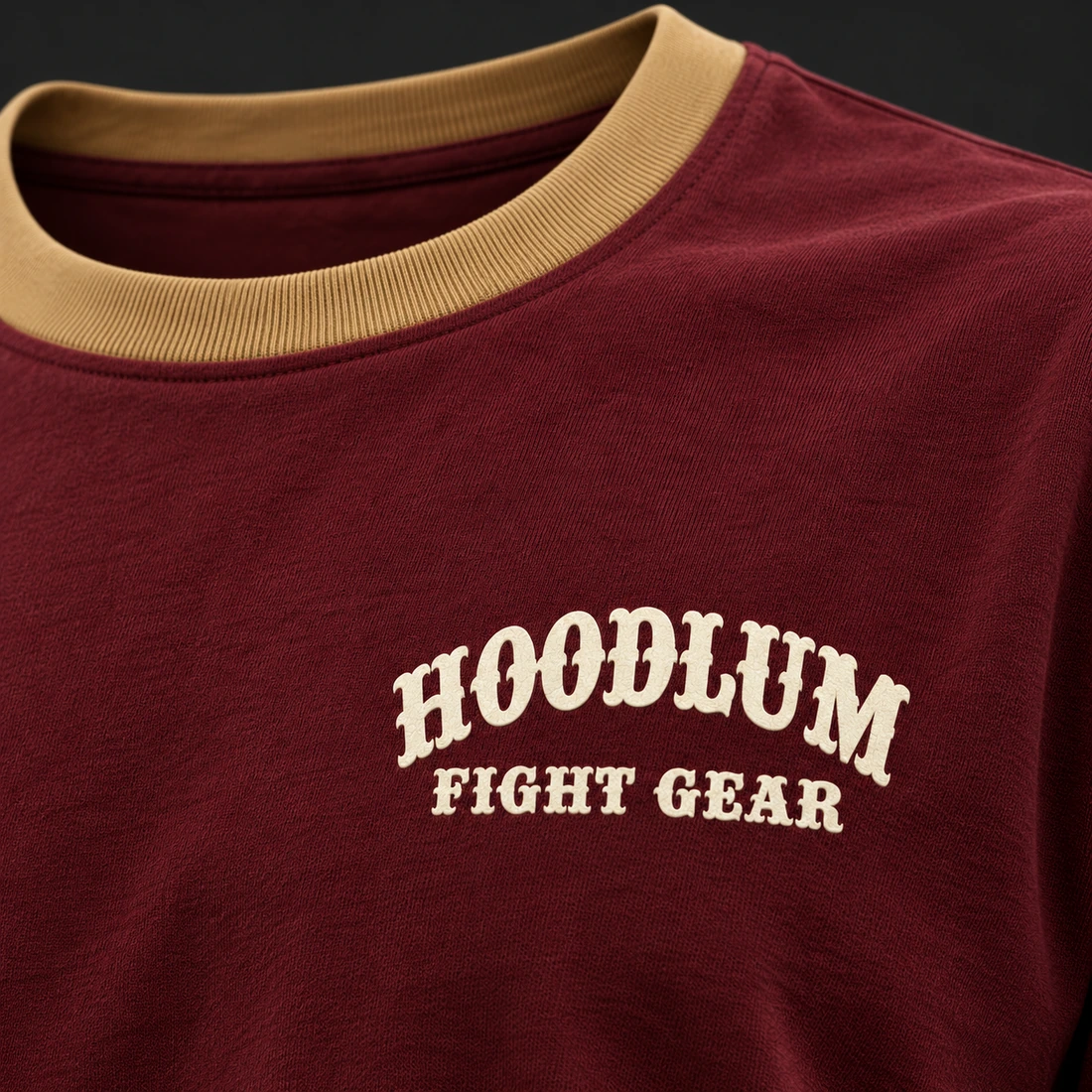 Quiet Rounds Longline Tee — Oxblood / Brass — Branding detail (AI demo concept)